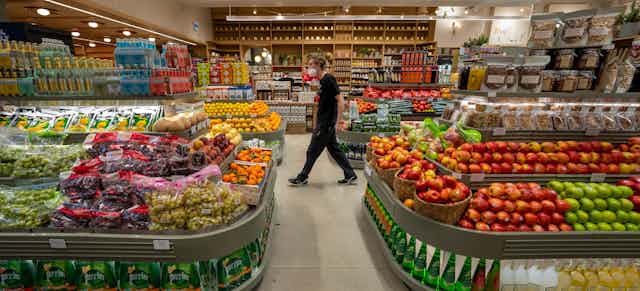 A man walking through a grocery strore