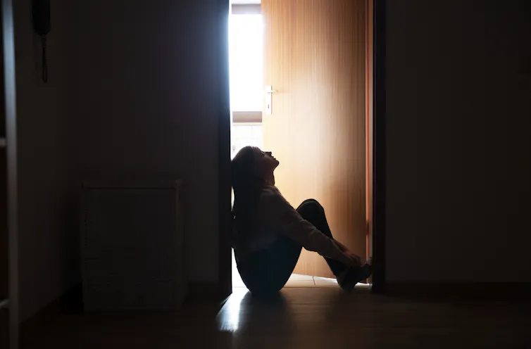 woman on floor by doorway