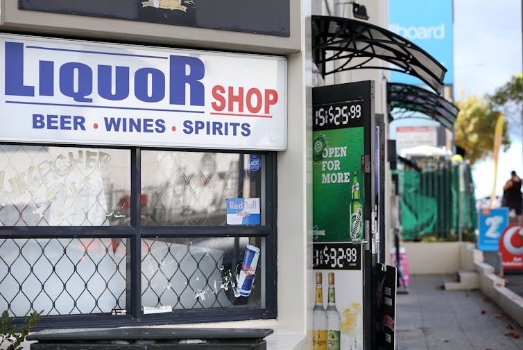 Outside of a liquor store with open door.