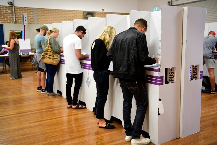 Voters at polling booths on election day.