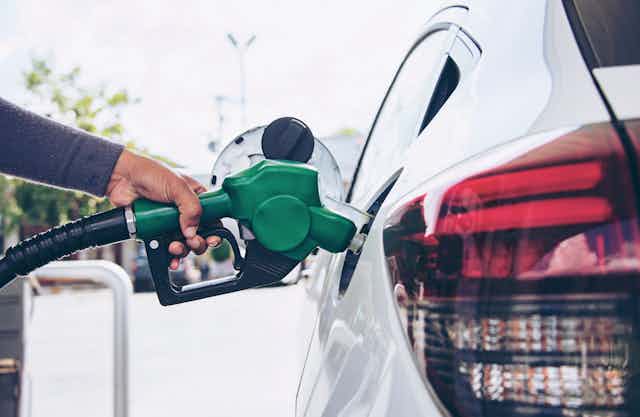 Person puts fuel into car