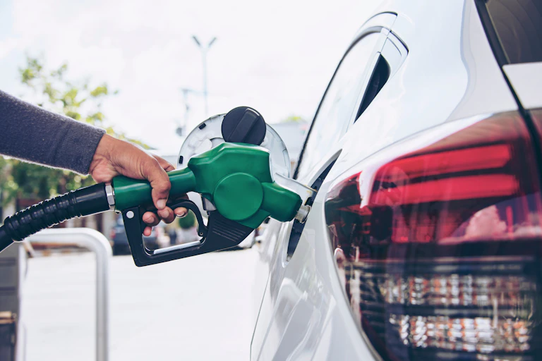 Person puts fuel into car