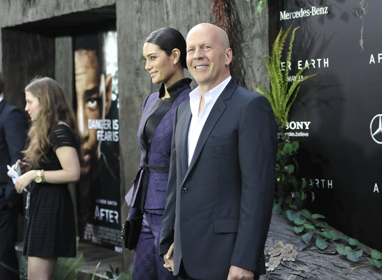 Bruce Willis and his wife on the red carpet.