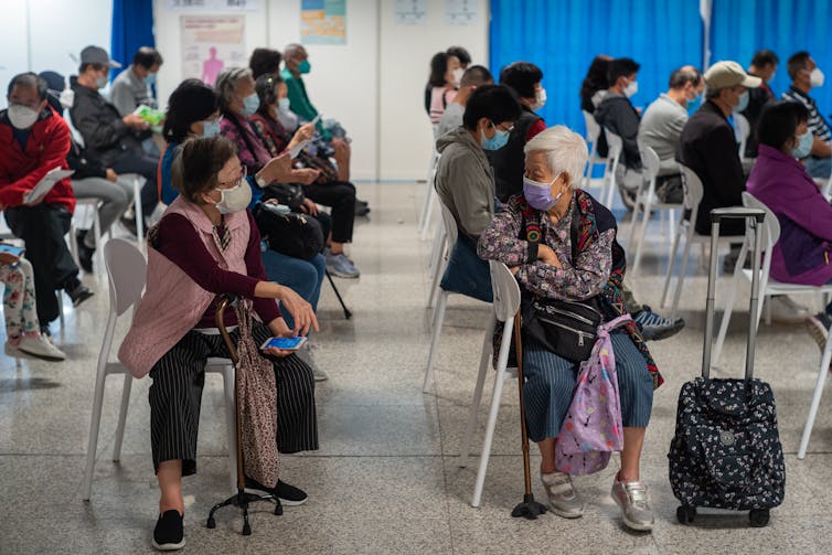 People in Hong Kong at a COVID vaccine centre