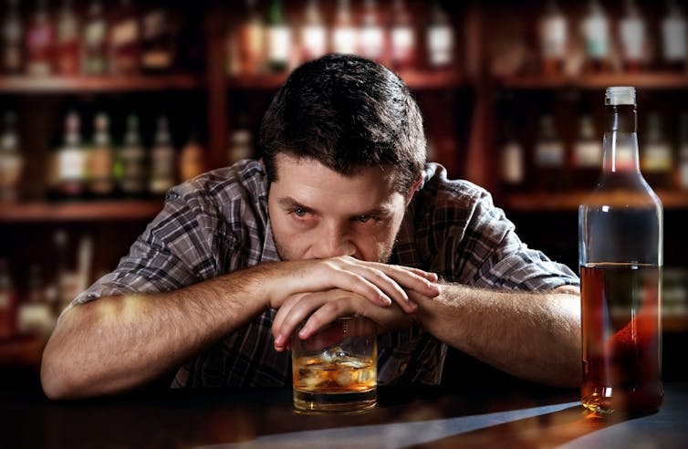 Image of a man drinking in bar.