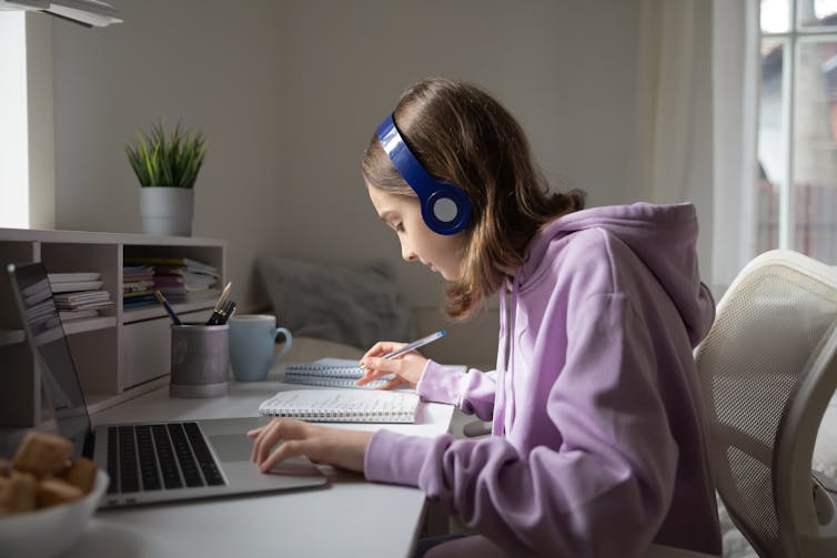 Girl working at laptop at home