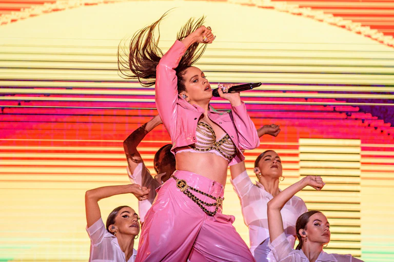Singer performs with backup dancers.