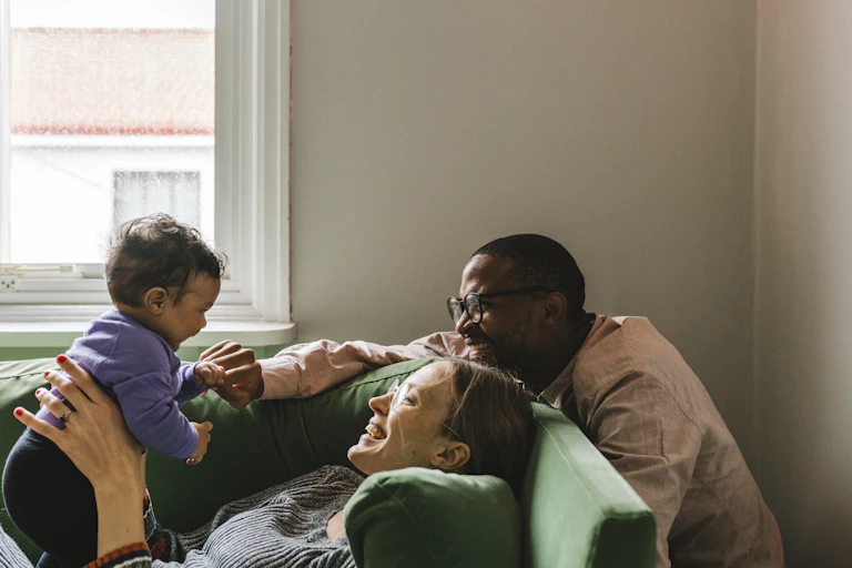 A couple plays with their baby
