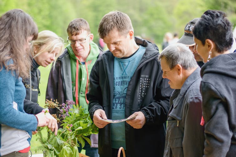 A group of people with intellectual disability participate in an outdoor activity.