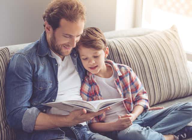 A father and son reading a book