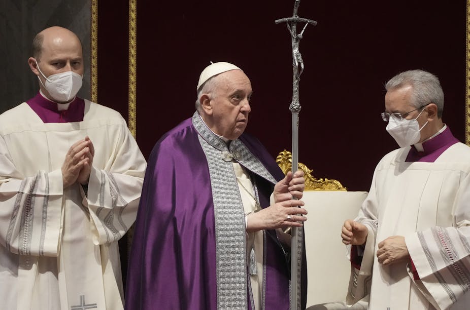 Pope Francis wearing a purple robe conducts a prayer service.