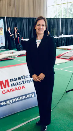 a woman stands in a judge's uniform