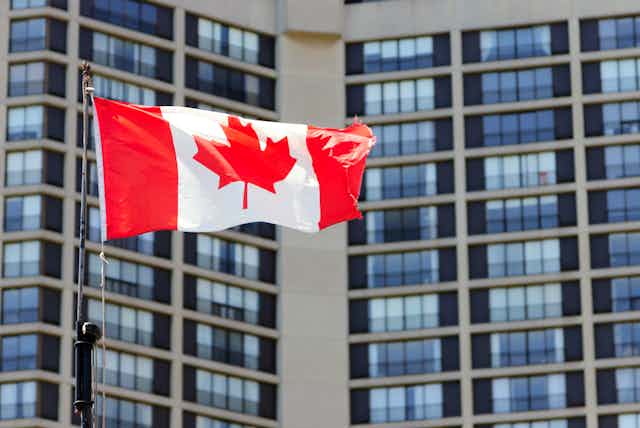 Canadian flag in front of office building