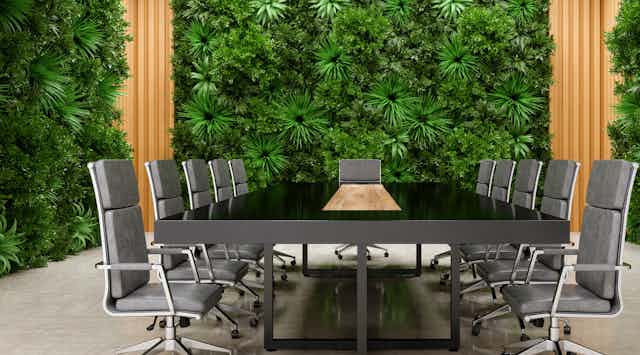 A gleaming corporate board room enveloped in lush green vegetation