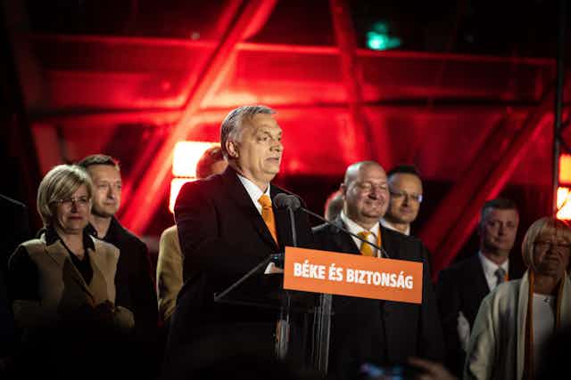 Hungarian president Viktor Orban giving a victory speech with his staff behind him.