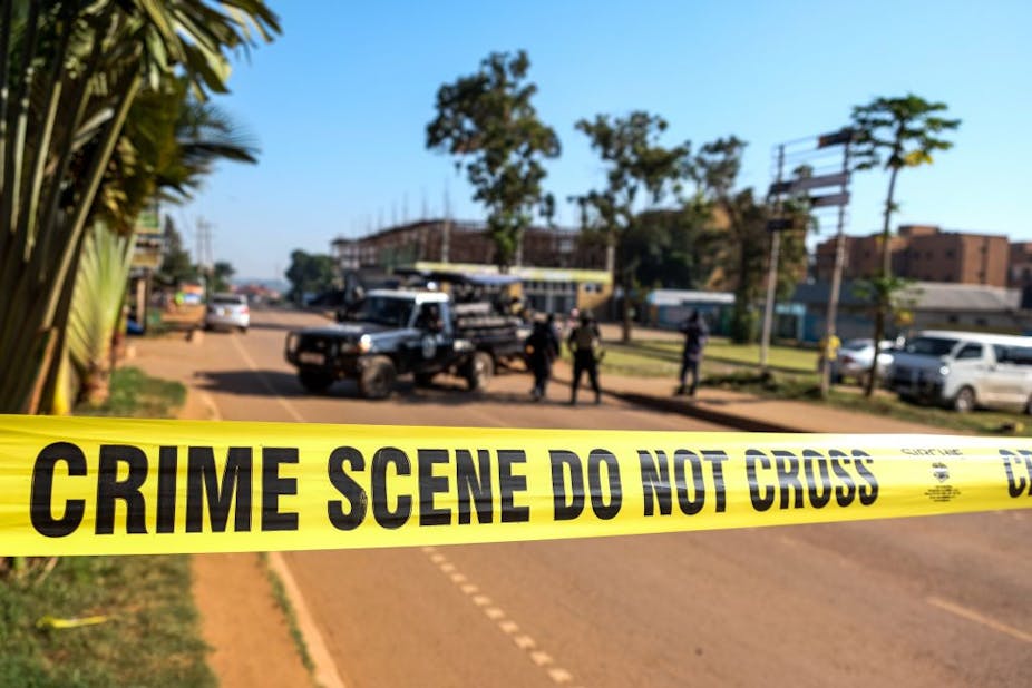 Crime scene tape across a road.