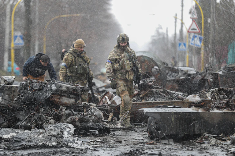 Ukrainians inspect abandoned Russian military vehicles in Bucha, outside Kyiv, April 2022