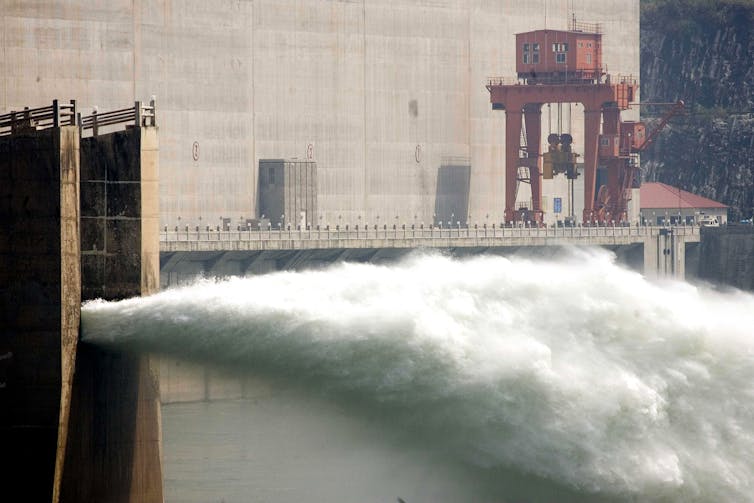 Water is seen spurting from a pipe in the wall.