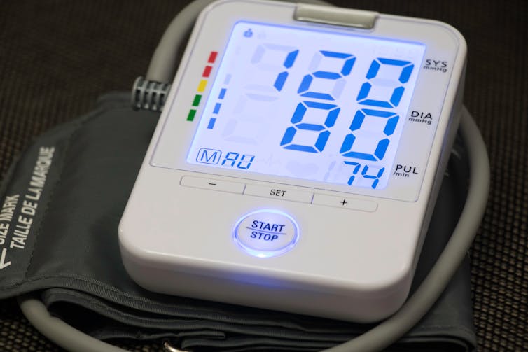 Blood pressure monitor showing 120 and 80