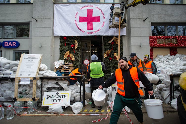 Ukrainian volunteers distribute aid.