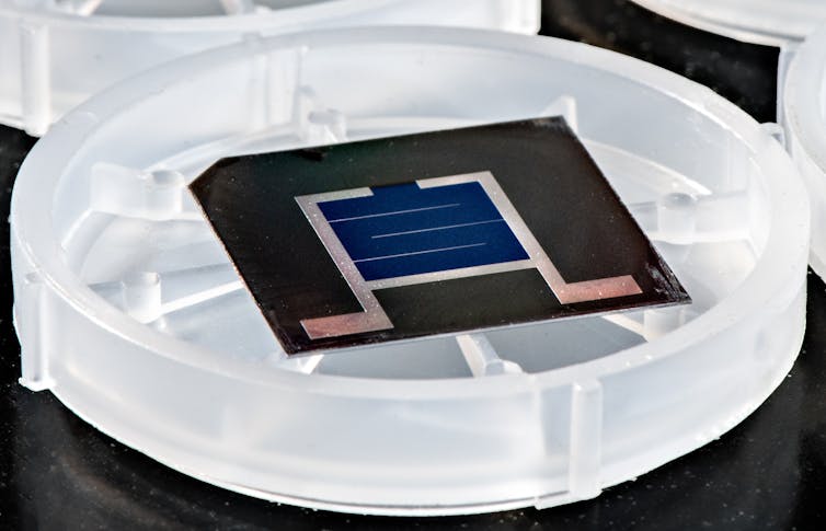 A small, square solar cell in plastic dish.