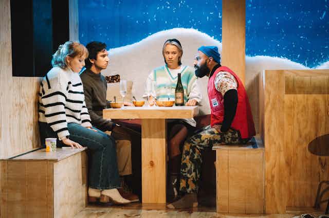 Production image: four people in a snow lodge