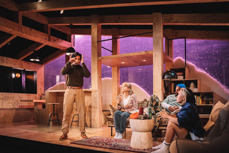 Production image: four people playing charades.