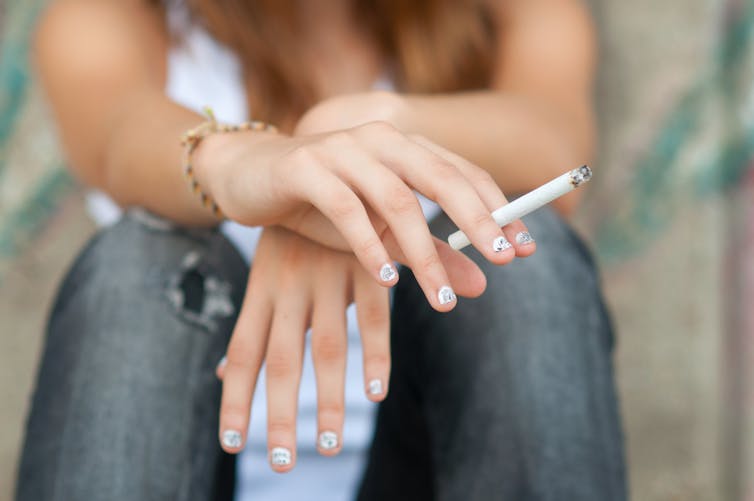 Teenage girl smoking cigarette