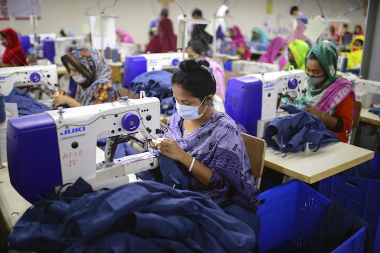Person sewing clothes in factory
