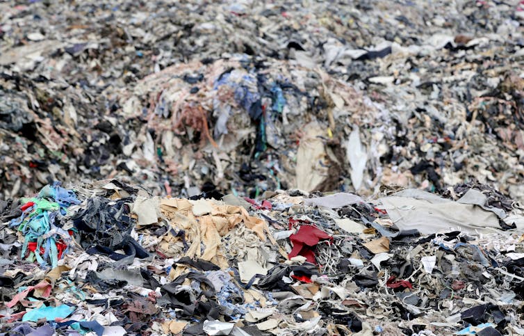 Pile of clothes in landfill