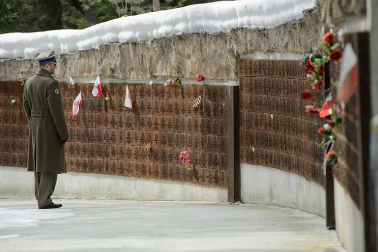 A Polish army officer looks at names on a memorial wall