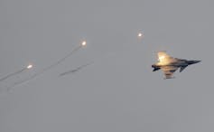 A fighter jet in a greyish sky.