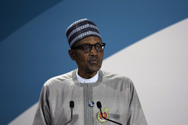 A man speaking from behind a podium