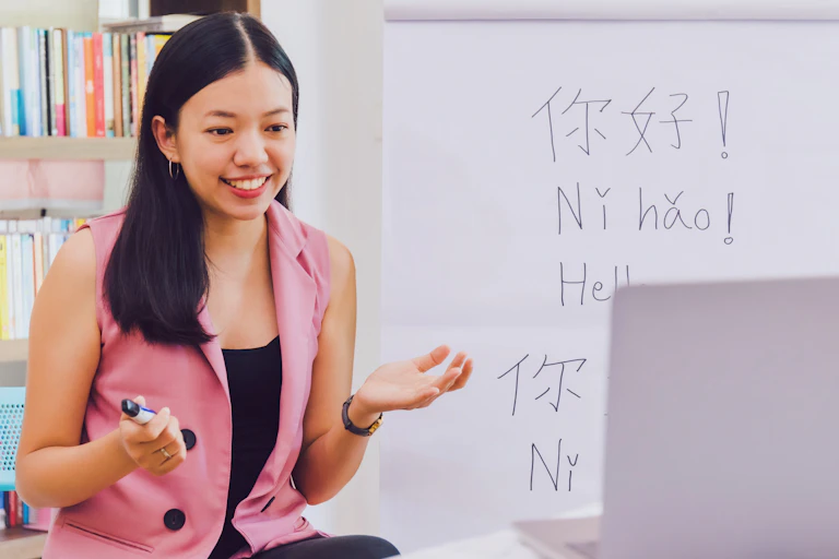 Woman in classroom with foreign languages on the blackboard