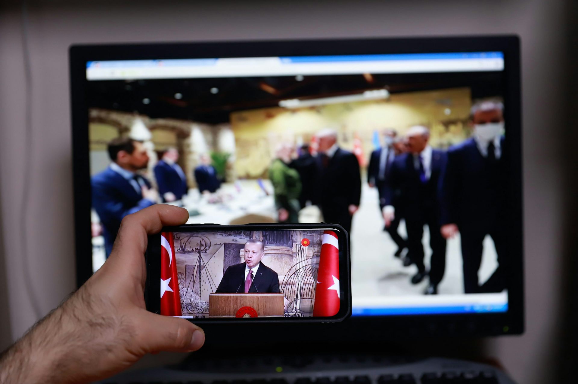 Someone filming Ukraine peace talks in Turkey on a mobile phone.