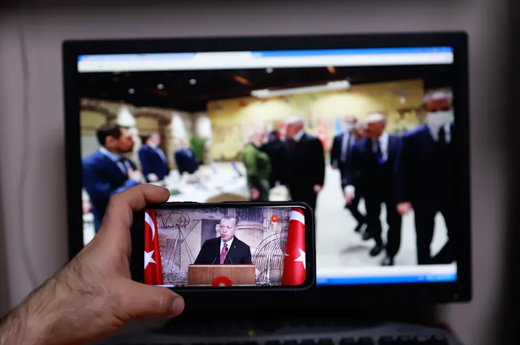 Someone filming Ukraine peace talks in Turkey on a mobile phone.