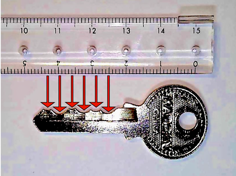 A ruler is next to a key. Red arrows show how the key's intendations are evenly spaced.