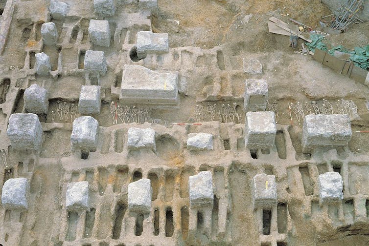 An eagle's-eye photograph shows a graveyard being exhumed.