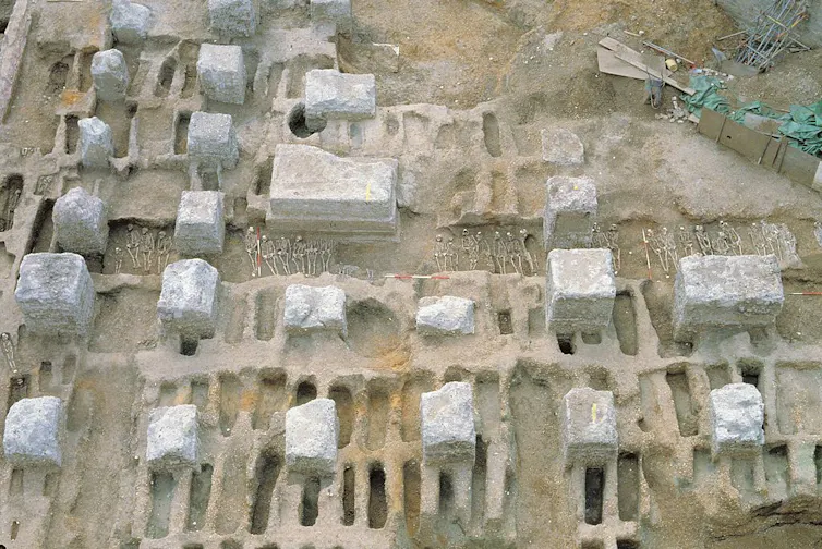 An eagle's-eye photograph shows a graveyard being exhumed.