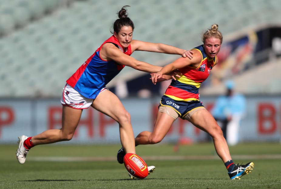 Two AFLW players going for the ball