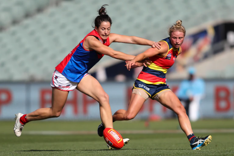 Two AFLW players going for the ball
