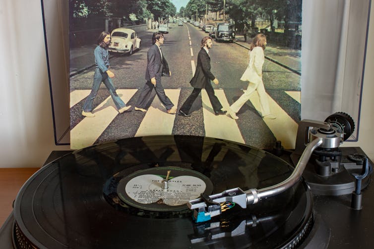 The Beatles album Abbey Road played a record behind the turntable.