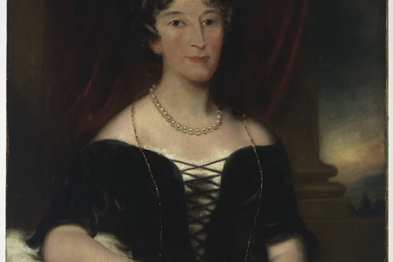 portrait of woman with hair up, curled, and pearls around her neck
