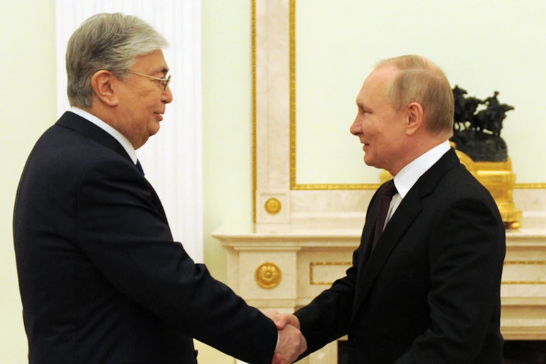 Kazakhstan's president Kassym-Jomart Tokayev shakes hands with Russian president Vladimir Putin at the Kremlin, February 2022