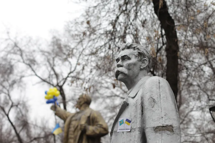 Statues in a park in the Kazakhstan capital Almaty decorated with Ukrainian colours.