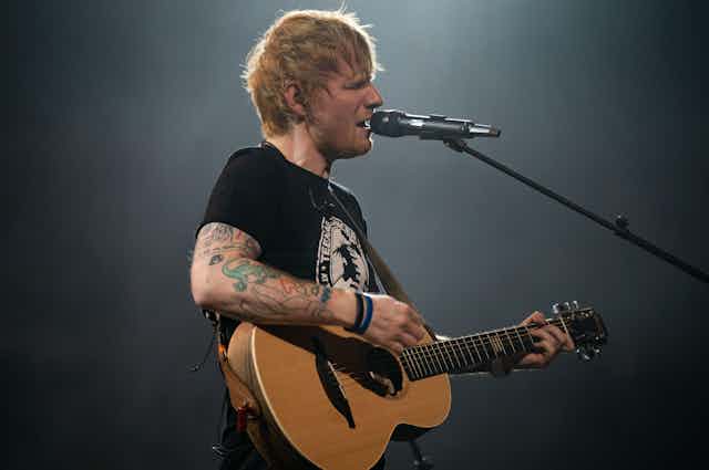 Ed Sheeran singing.