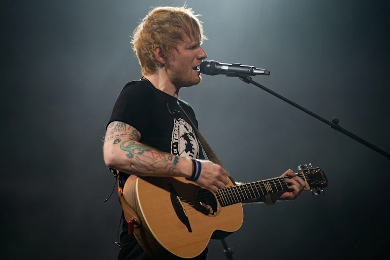 Ed Sheeran singing.