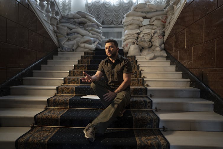 Ukrainian President Volodymyr Zelenskyy sitting on stairs
