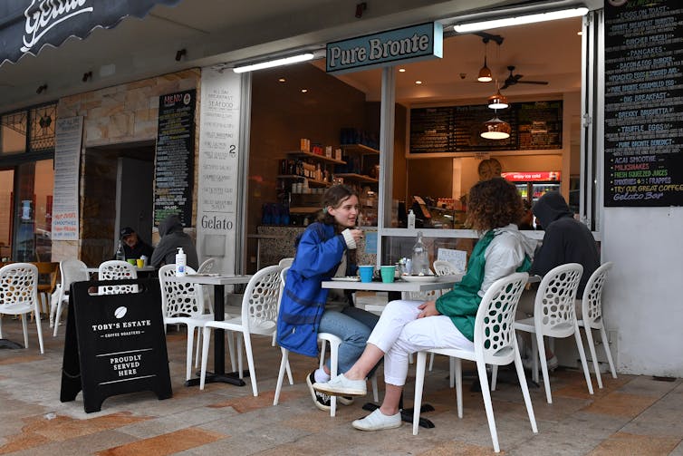 Diners sit a a cafe following 108 days of lockdown at Bronte in Sydney, Monday, October 11, 2021.