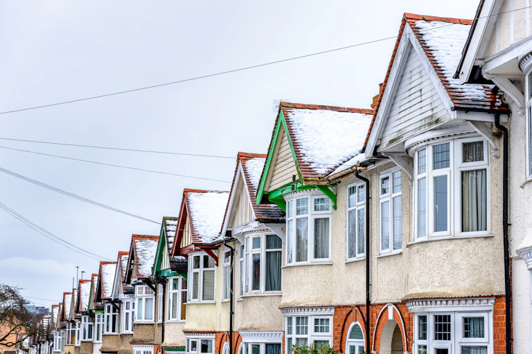 A row of terraced houses covered in snow.